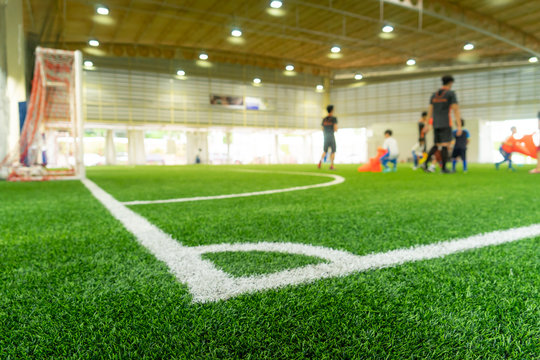 Modern sports facility with athletes training on indoor basketball court and weightlifting area